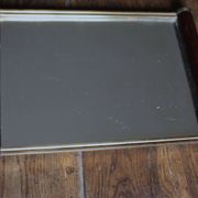 Rectangular mirror tray with wooden handles and gilding.