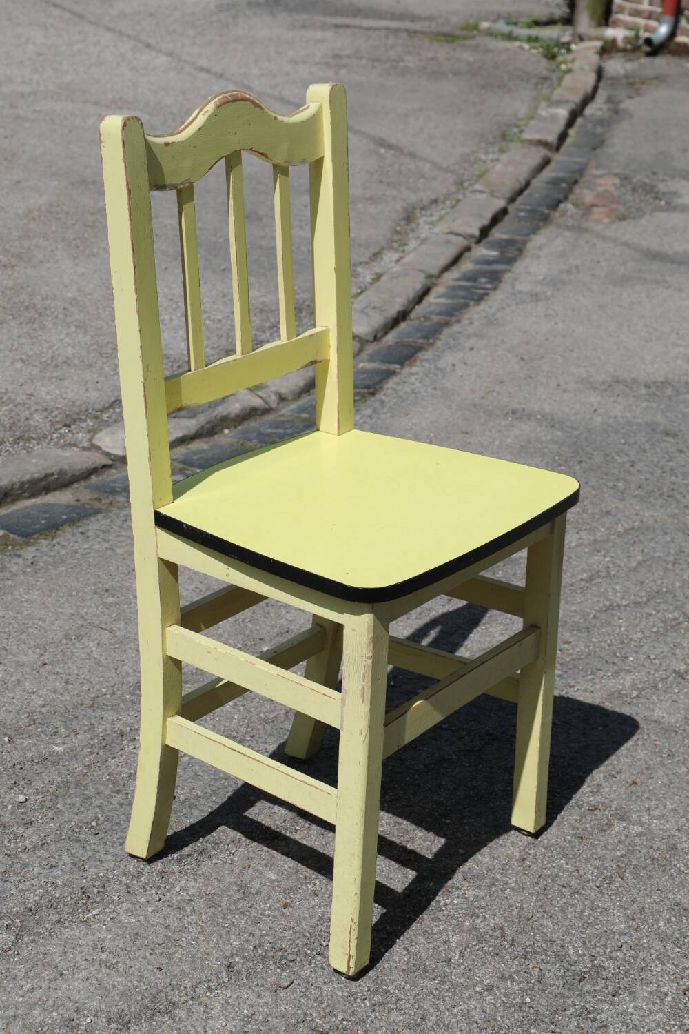 Formica and yellow wood chair