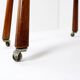 Vintage solid wood side table on casters