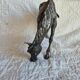 Sculpture of a grazing horse with a silver finish.