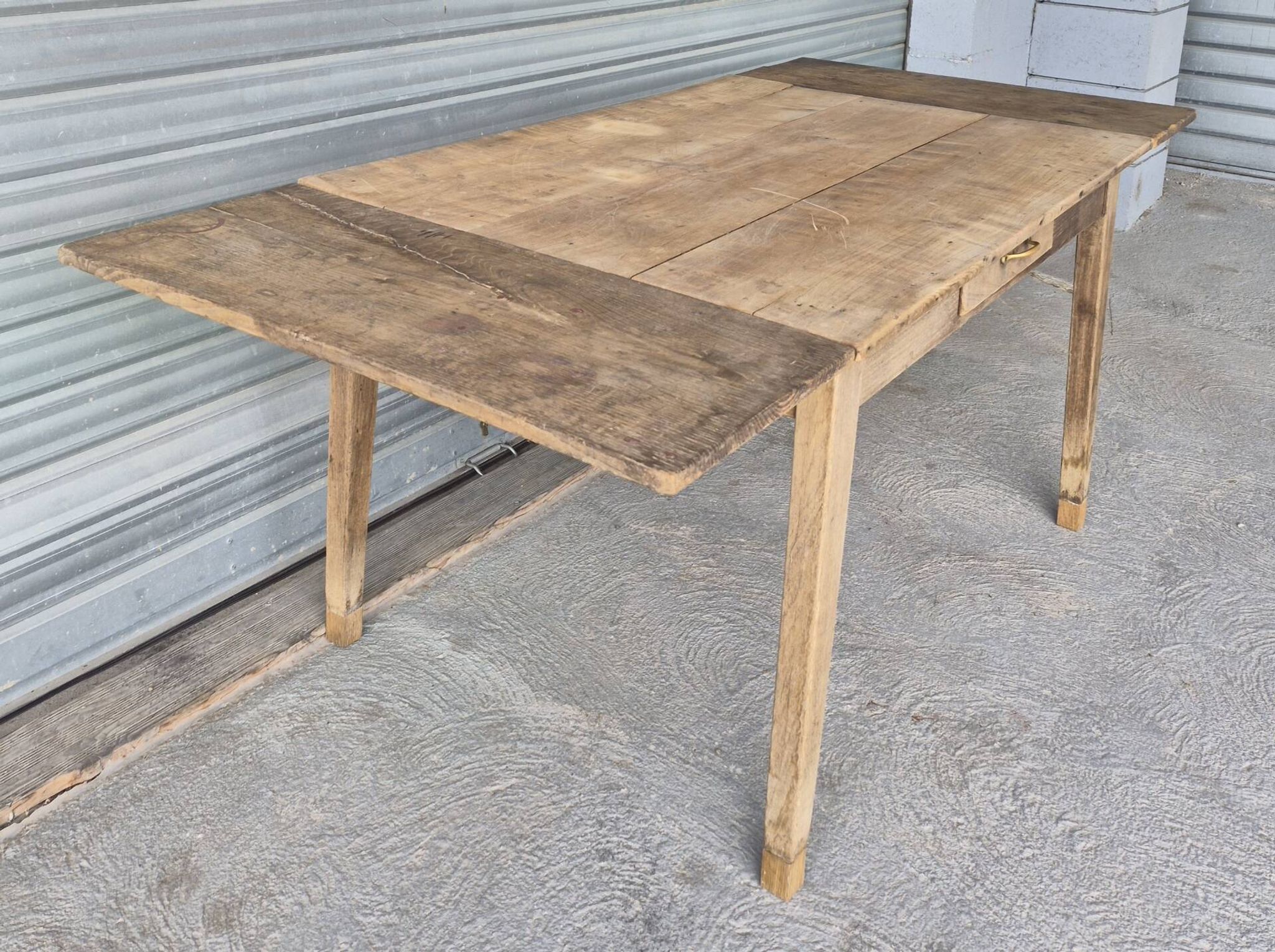 Old farmhouse table with its 2 extensions and raised legs.