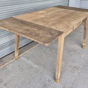 Old farmhouse table with its 2 extensions and raised legs.