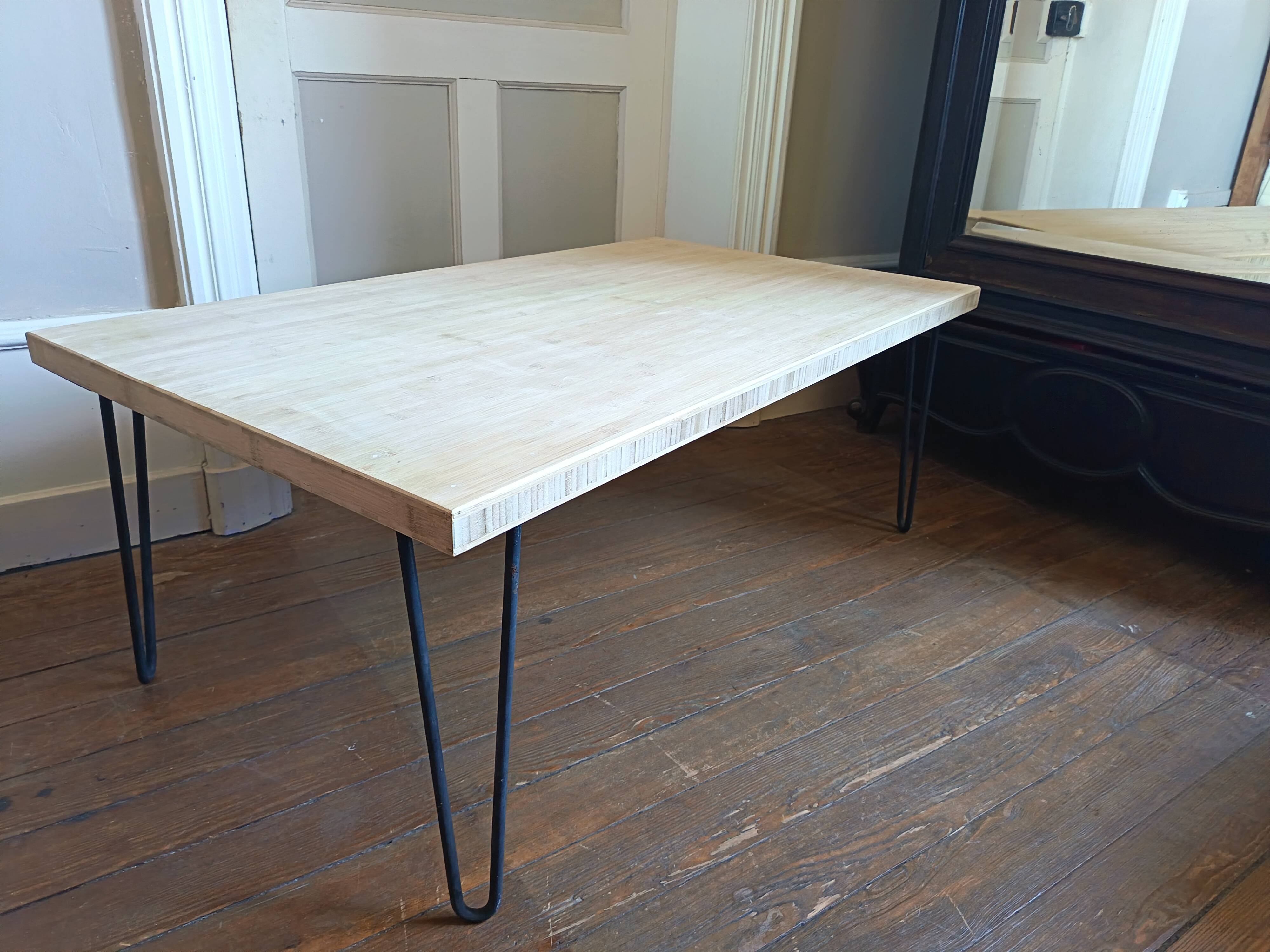 Coffee table in solid bamboo with steel legs.