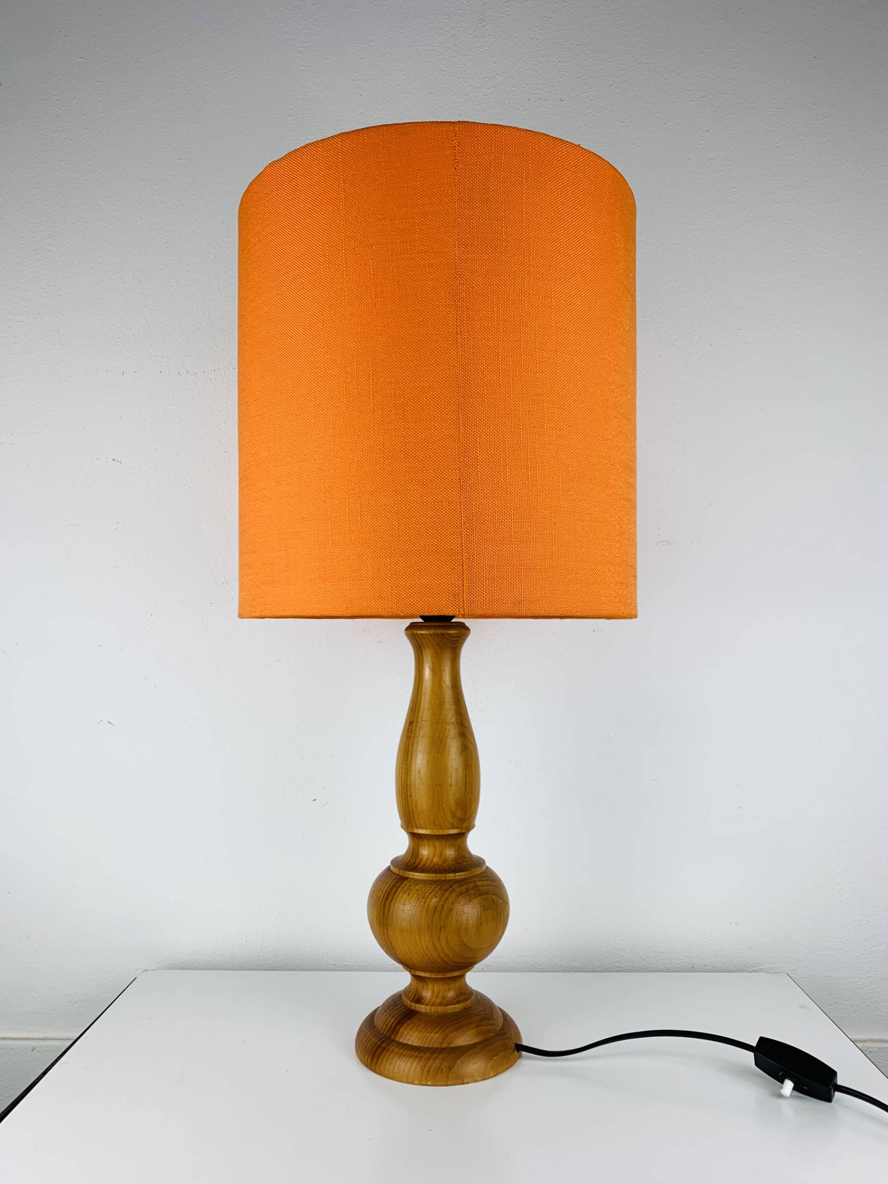 Turned wood lamp with orange shade, 1970s.