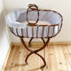 Vintage rattan cradle and its wheeled support