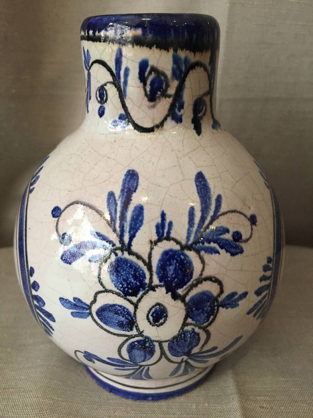 Small white decorative vase with blue floral decoration
