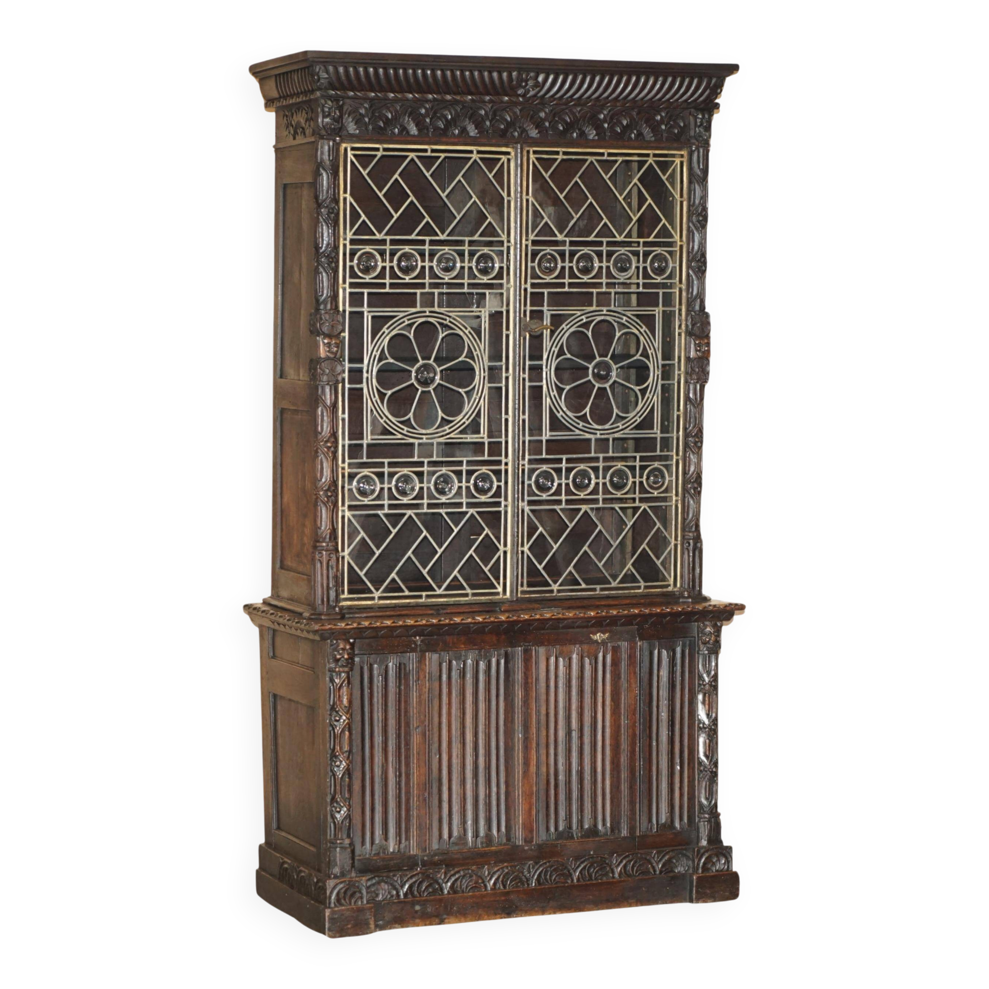 Jacobean hardwood library with carved panels and glass doors.
