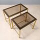 Nested tables in brass and smoked glass.