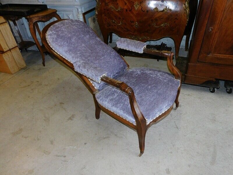 Relaxed Voltaire armchair with walnut racks