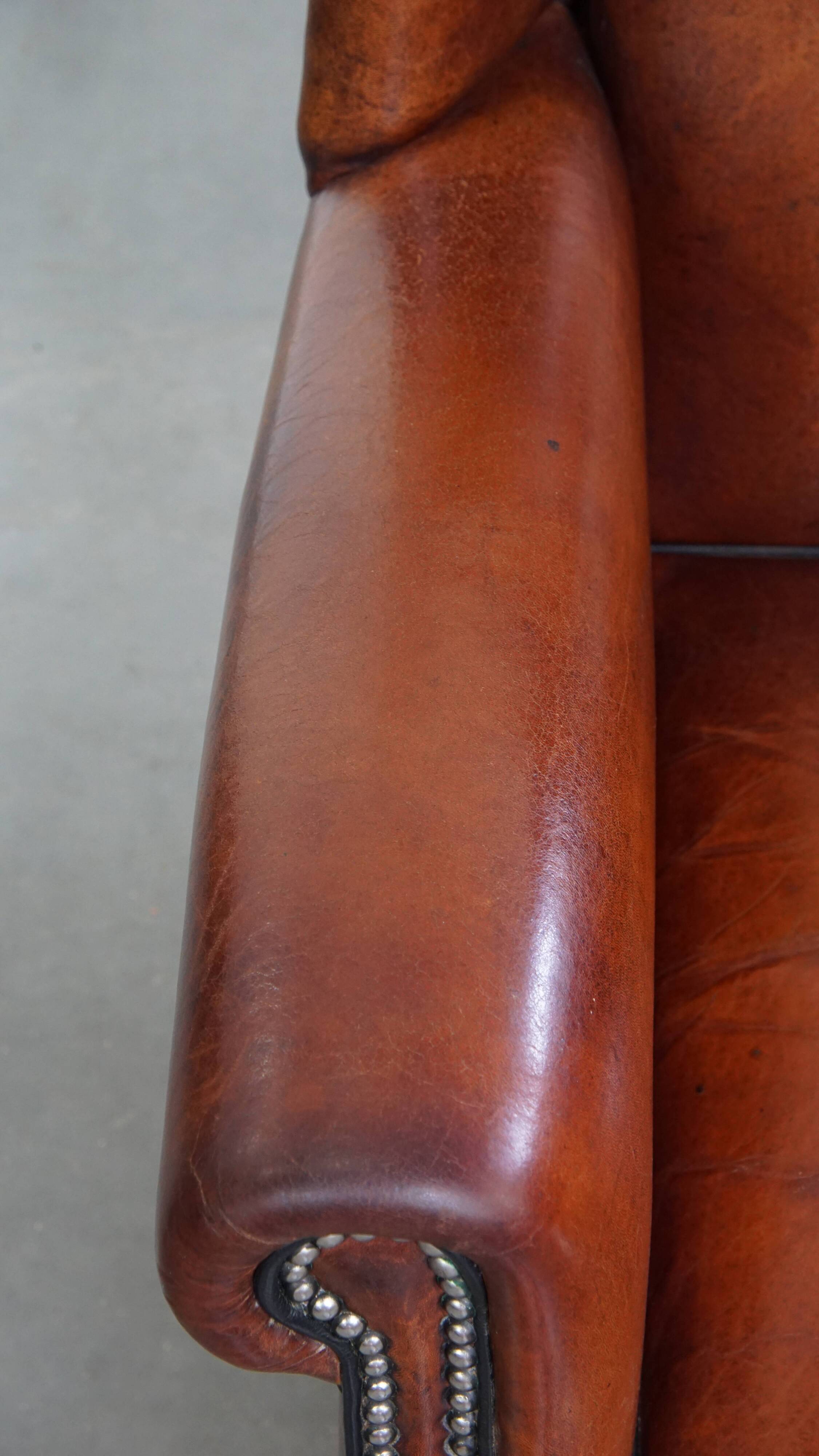 Sheepskin Wingback Chair with Warm Tones and Black Piping