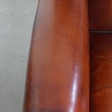 Sheepskin Wingback Chair with Warm Tones and Black Piping