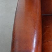 Sheepskin Wingback Chair with Warm Tones and Black Piping