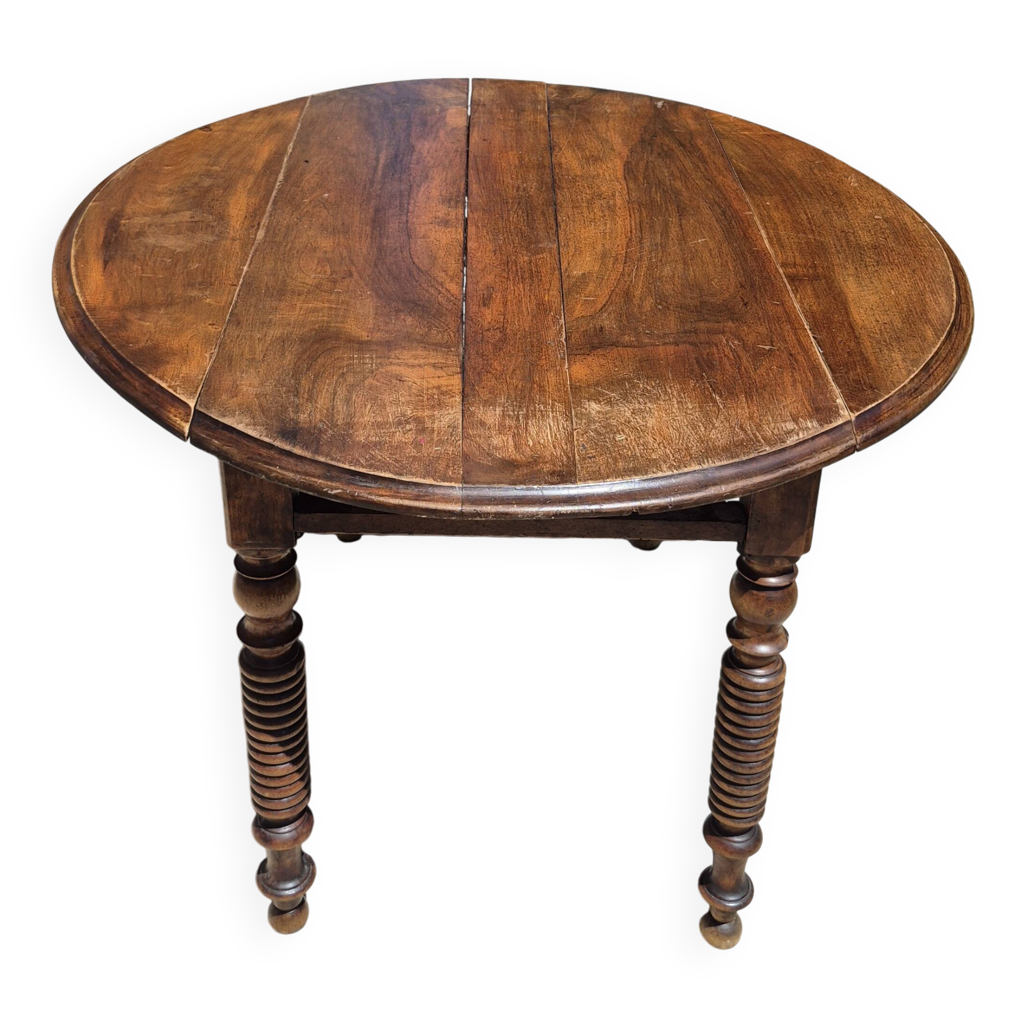 Round dining table with a drop-leaf top in solid walnut, late 19th century.