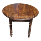 Round dining table with a drop-leaf top in solid walnut, late 19th century.