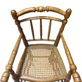 Antique bamboo caned baby chair from the early 20th century.