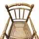 Antique bamboo caned baby chair from the early 20th century.