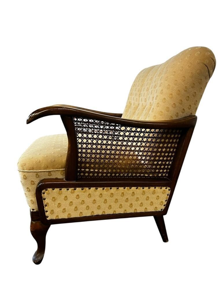 Vintage wooden armchair with rattan weaving.