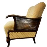 Vintage wooden armchair with rattan weaving.