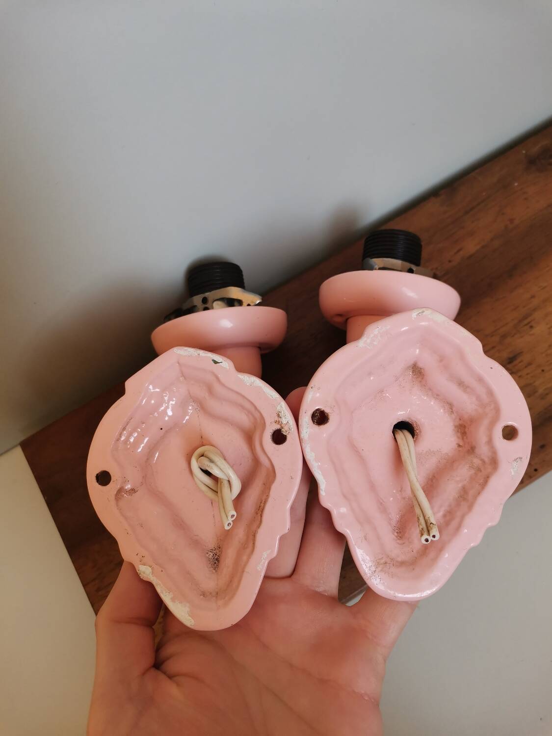 Set of 2 vintage pastel pink enamelled cast iron wall lamps