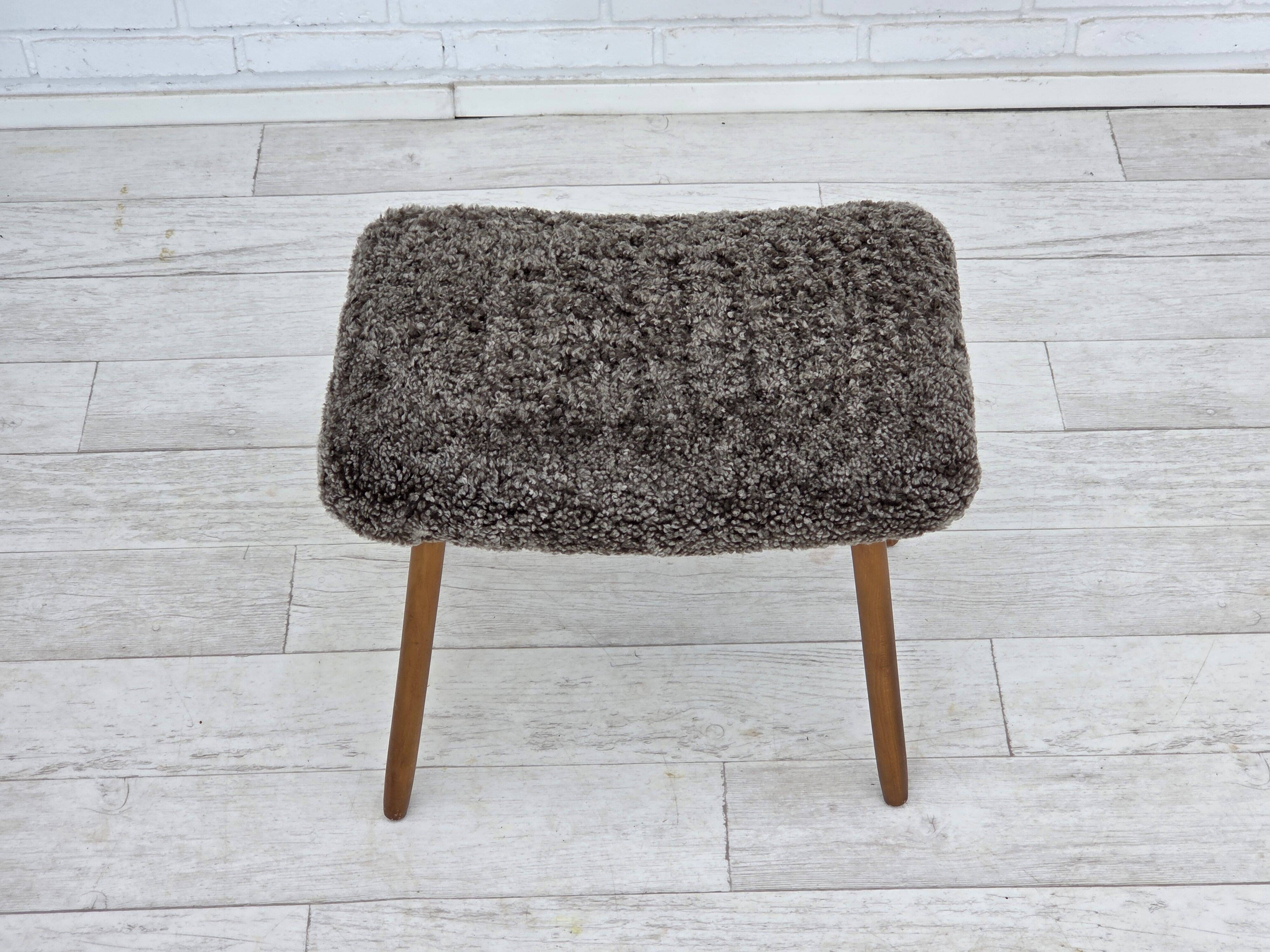 1960s, reupholstered Danish armchair, with stool, genuine sheepskin.
