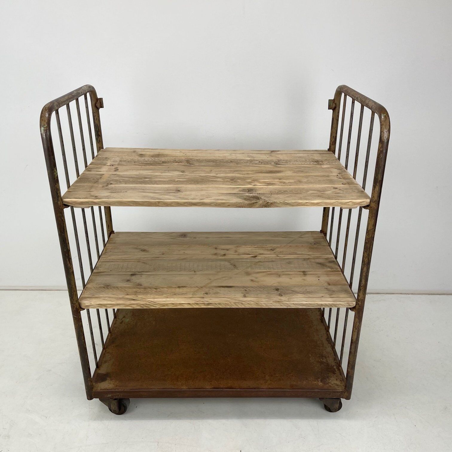 Vintage industrial iron and wood shelves on wheels