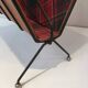 Magazine rack in black lacquered metal, leather and checkered fabric