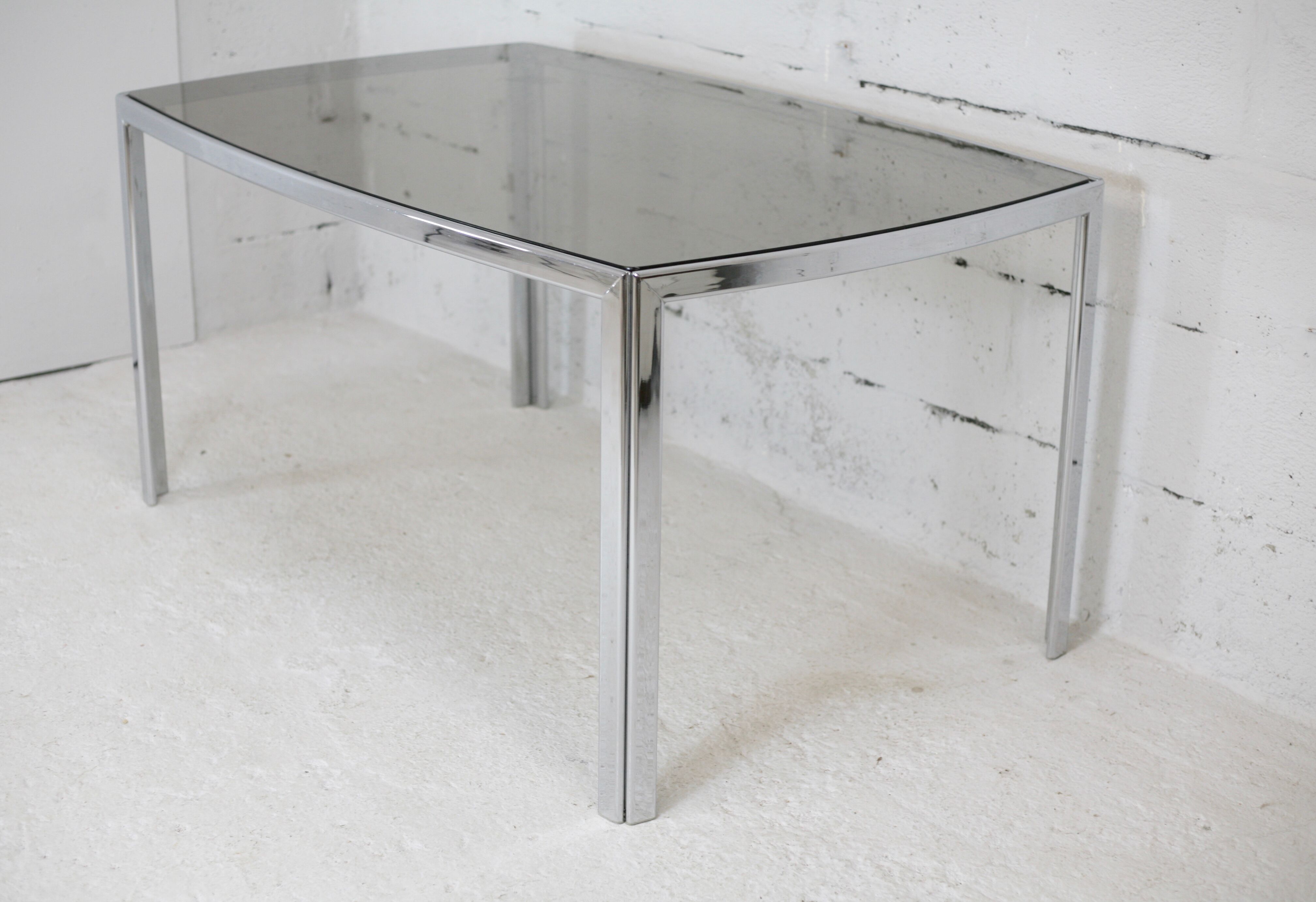 Living table. chrome metal, curved smoked glass slab, france, circa 1970.