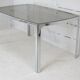 Living table. chrome metal, curved smoked glass slab, france, circa 1970.