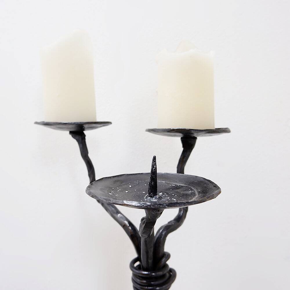 Large wrought iron candelabrum with an abstract design and three candle holders.