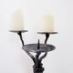Large wrought iron candelabrum with an abstract design and three candle holders.