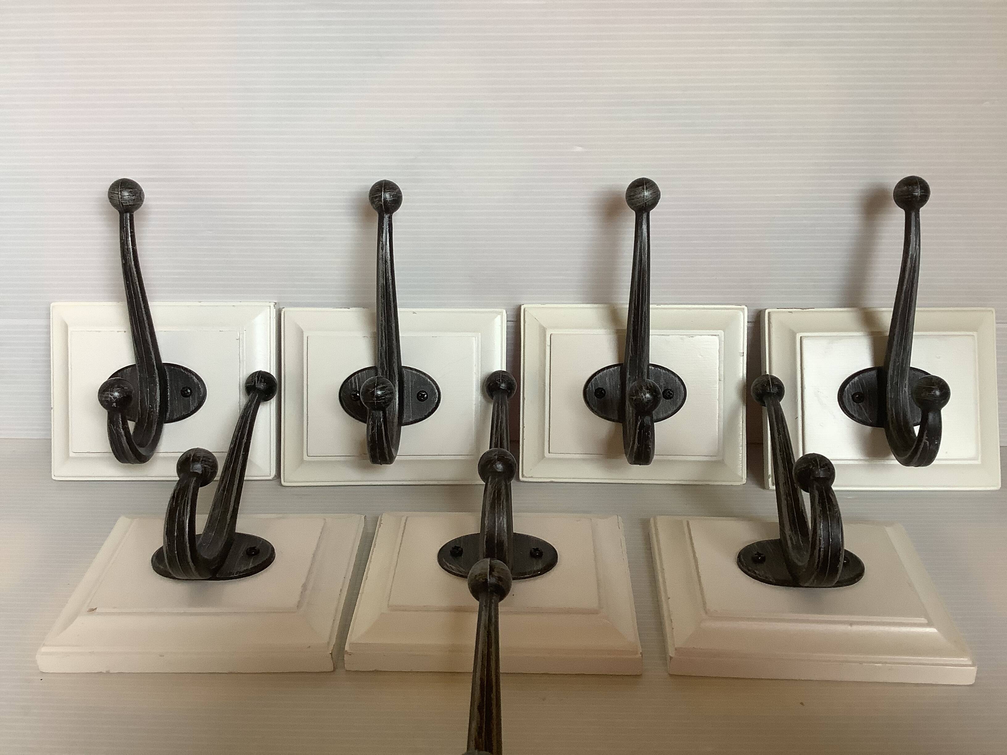 Eight double white wood metal hooks
