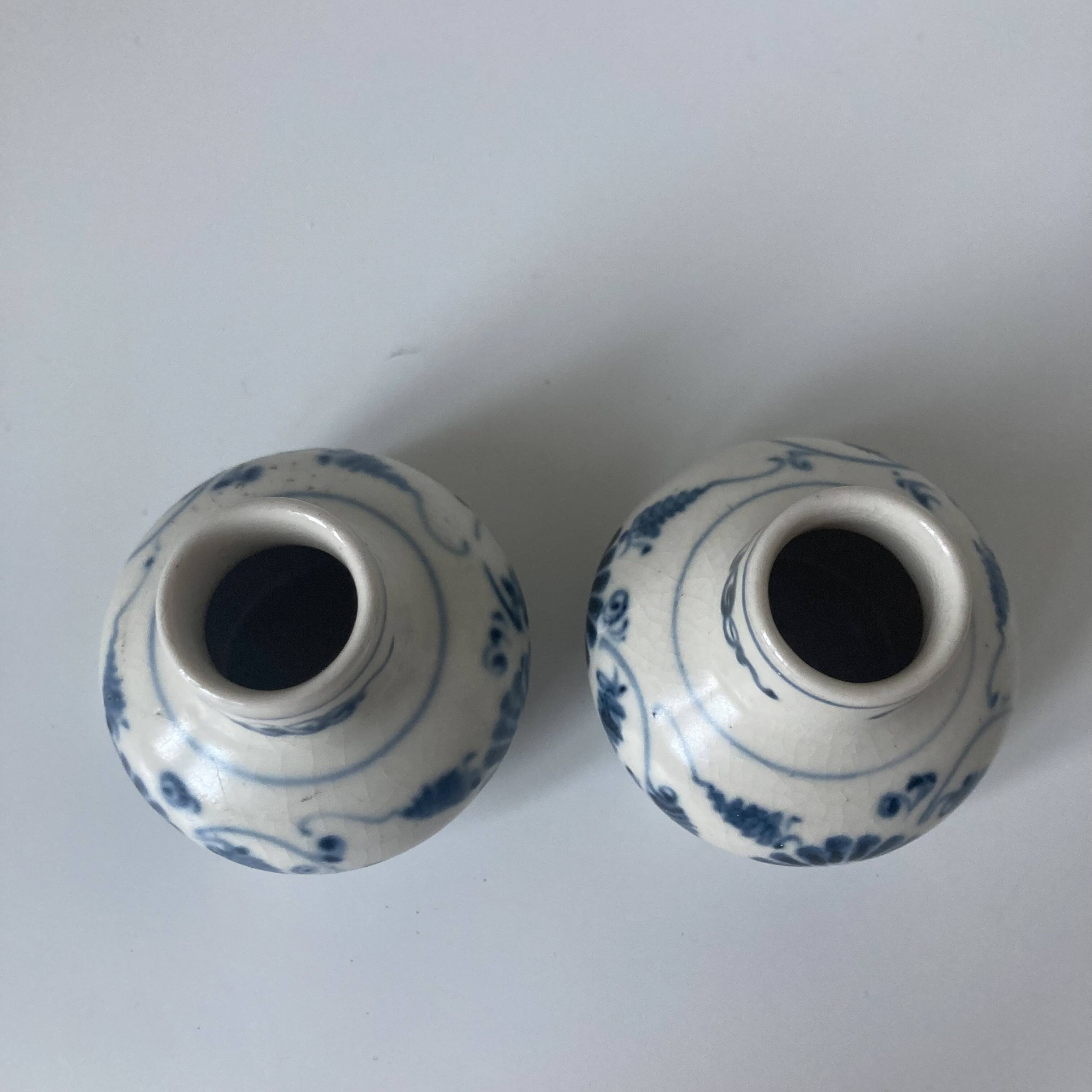 Pair of miniature blue and white Vietnamese ceramic vases with floral decoration.