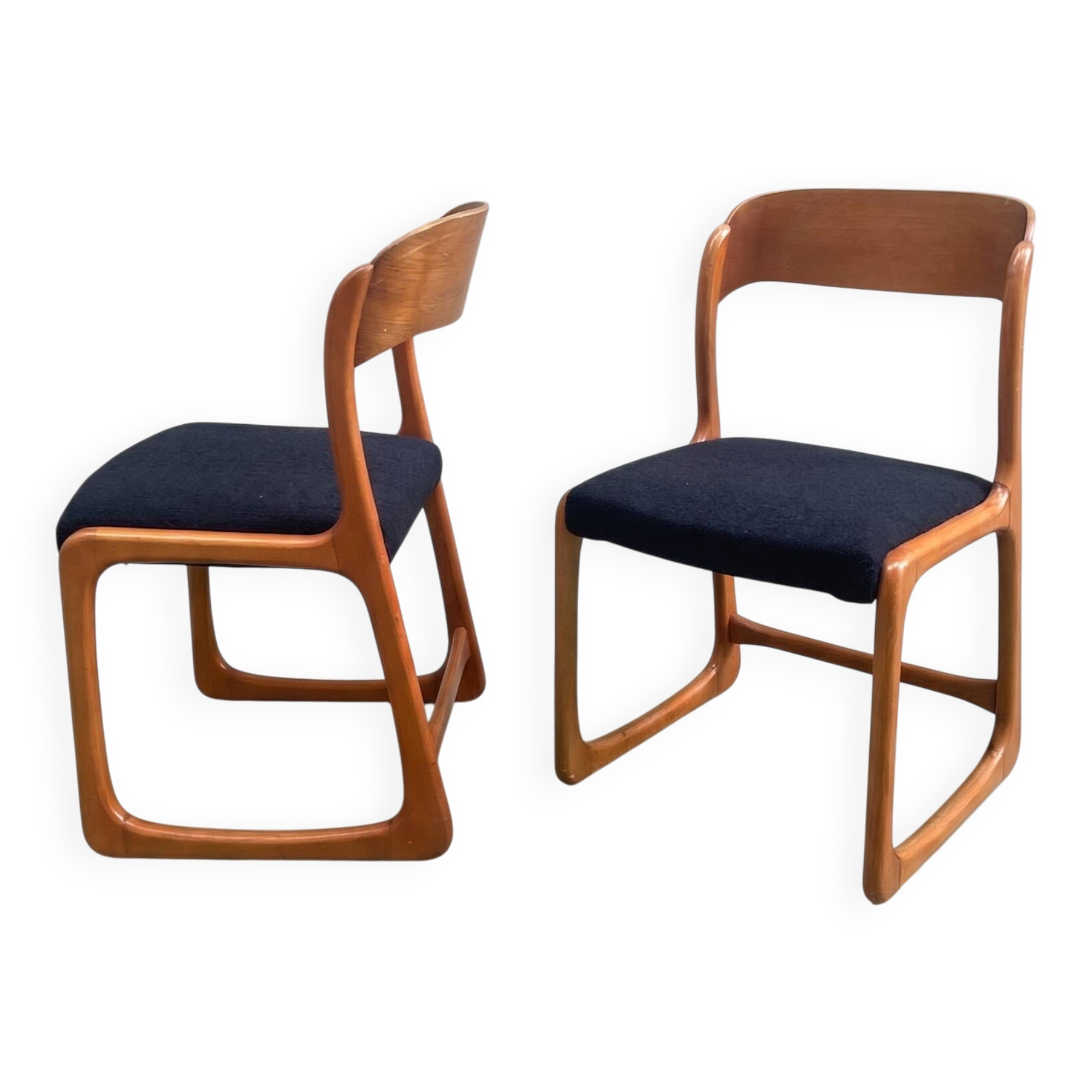 Pair of vintage Baumann sled chairs with curved wood in honey colour.