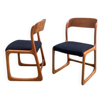 Pair of vintage Baumann sled chairs with curved wood in honey colour.