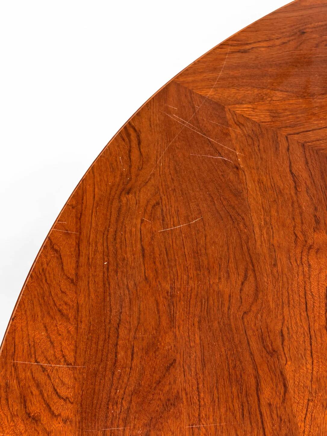 Large round dining table with black blade legs.