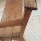 Church bench in fir tree with armrests