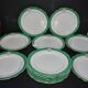 Paris porcelain set of 12 flat plates with green border and gold monogram JC.