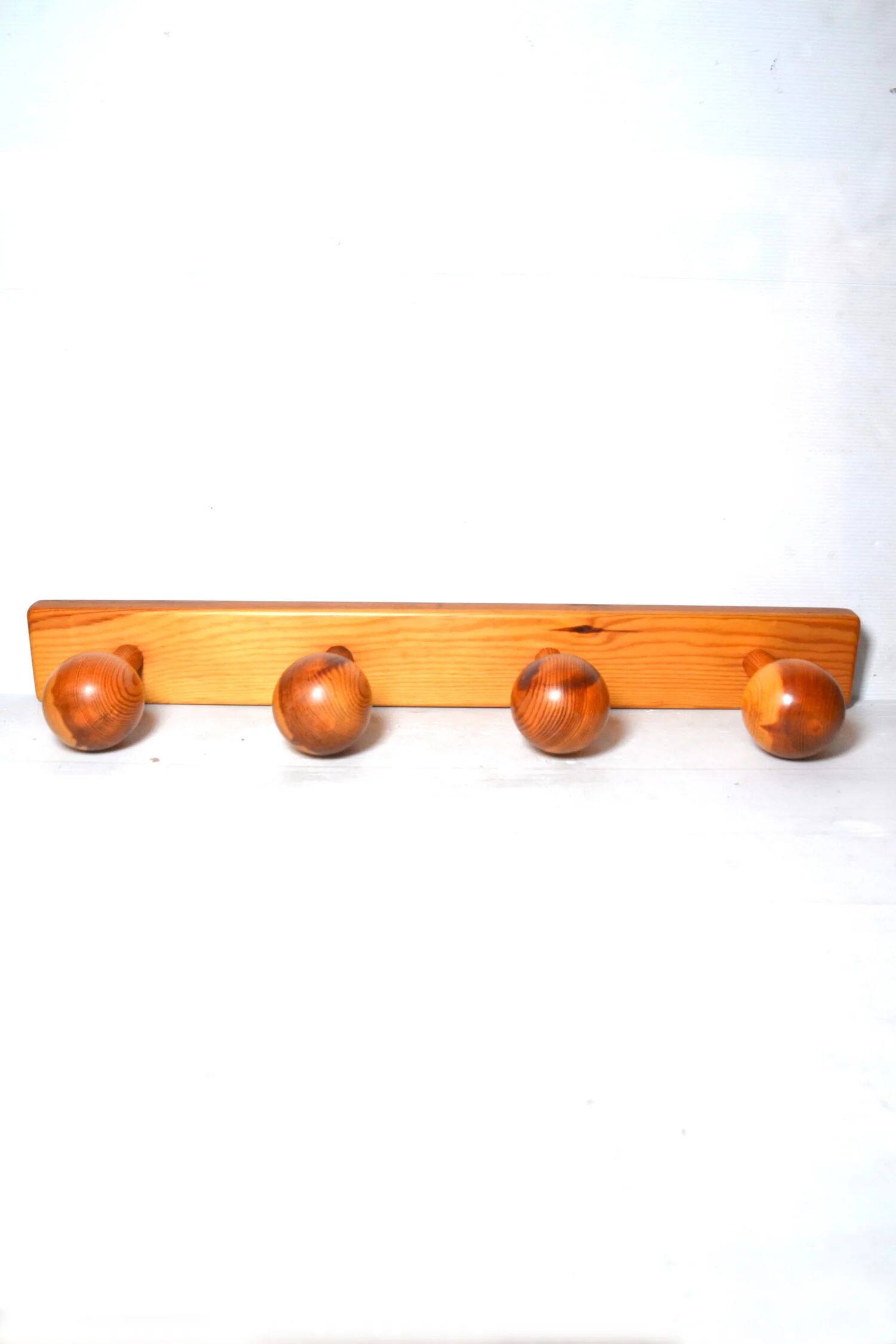 Vintage wall-mounted coat rack in solid pine.