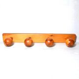 Vintage wall-mounted coat rack in solid pine.