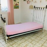 Old white metal and brass bed