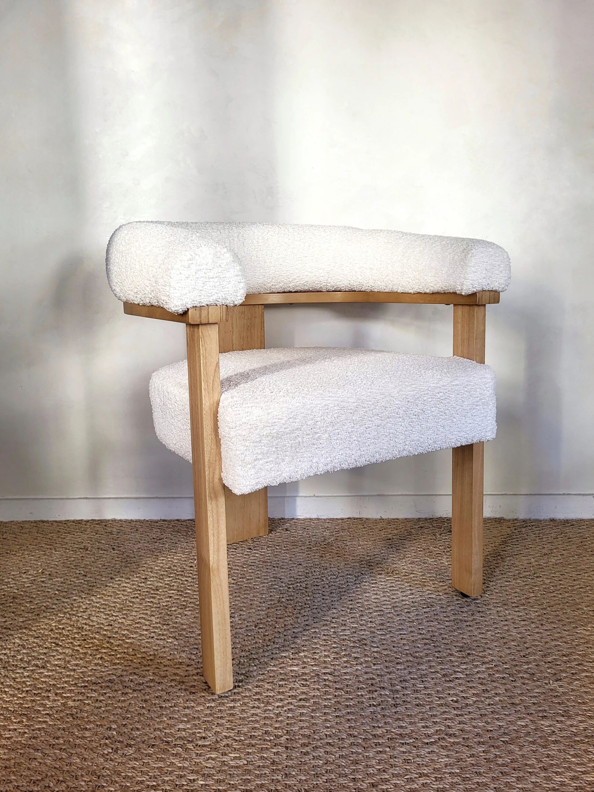 Contemporary armchair in wood and white bouclé fabric