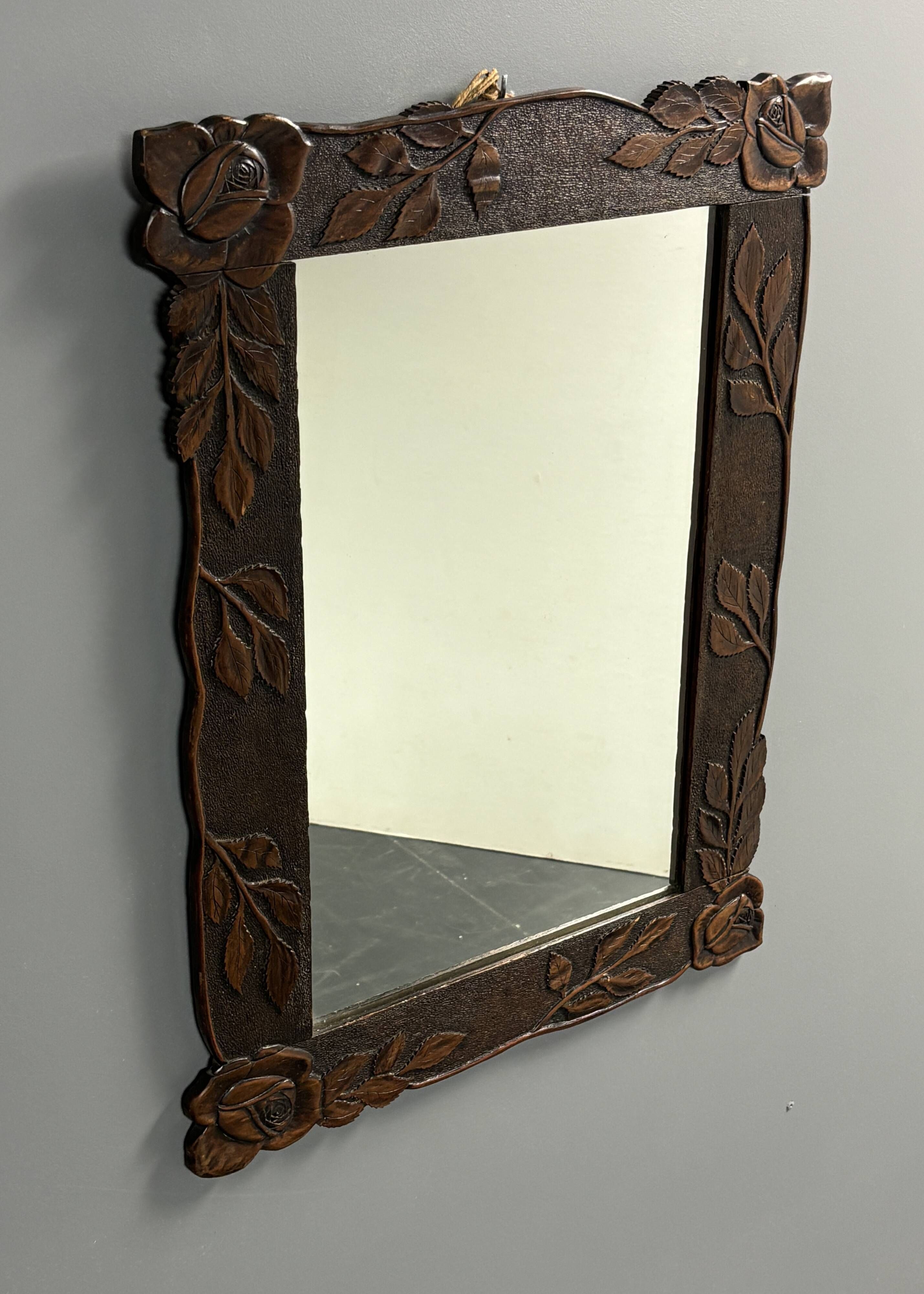 Arts & Crafts hand-carved wall mirror with floral roses, early 20th century
