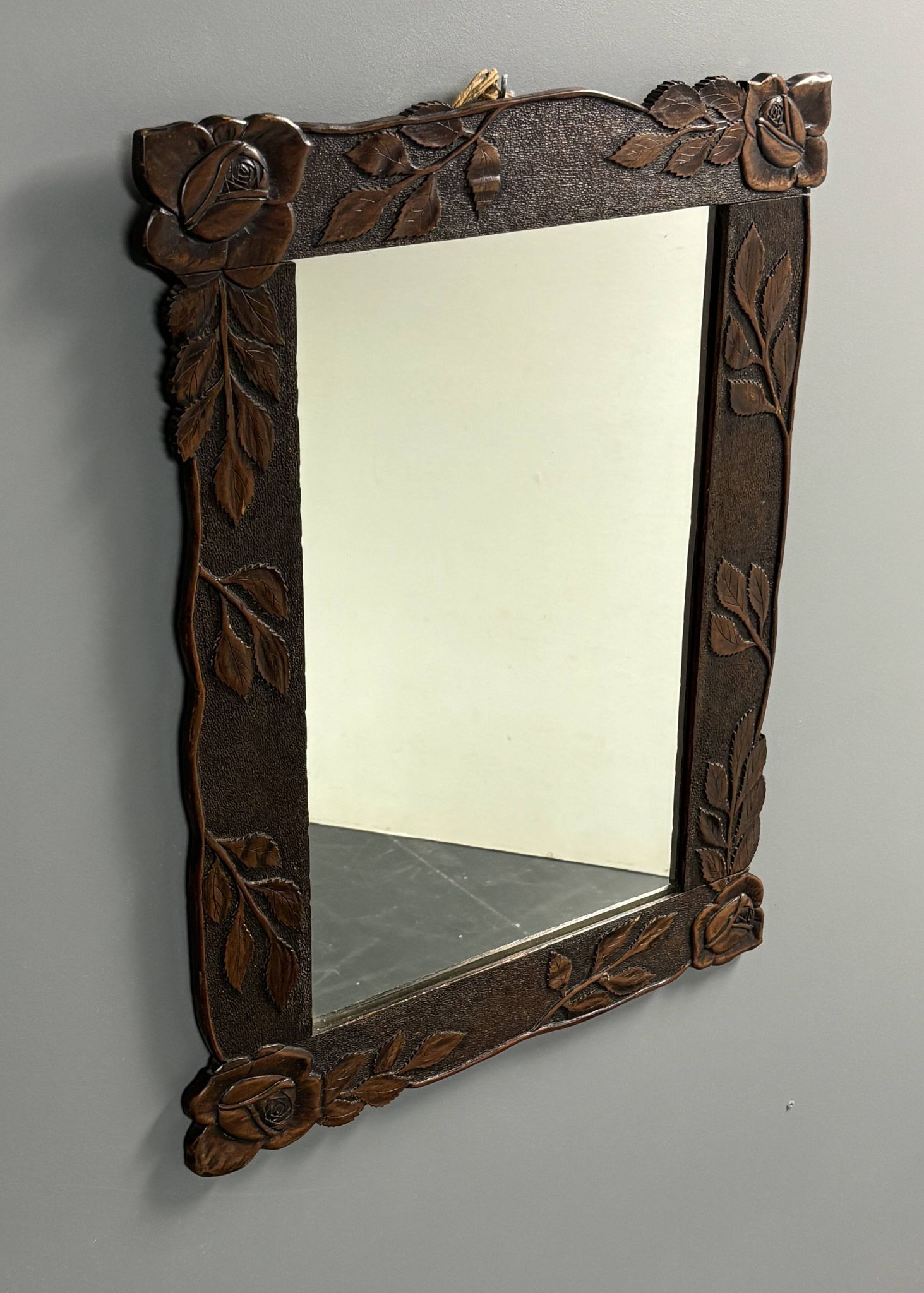 Arts & Crafts hand-carved wall mirror with floral roses, early 20th century