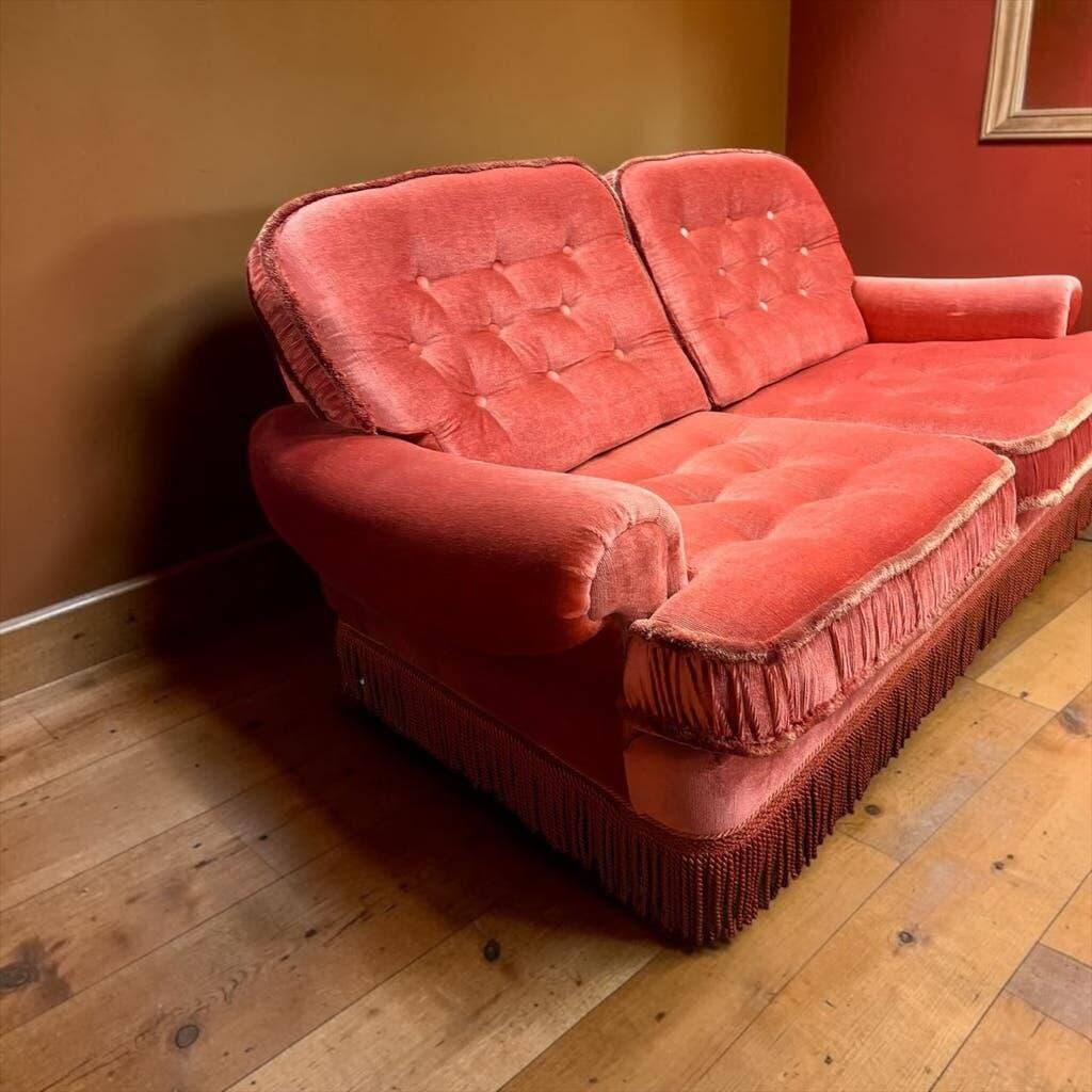 Vintage pink two-seater sofa with fringes