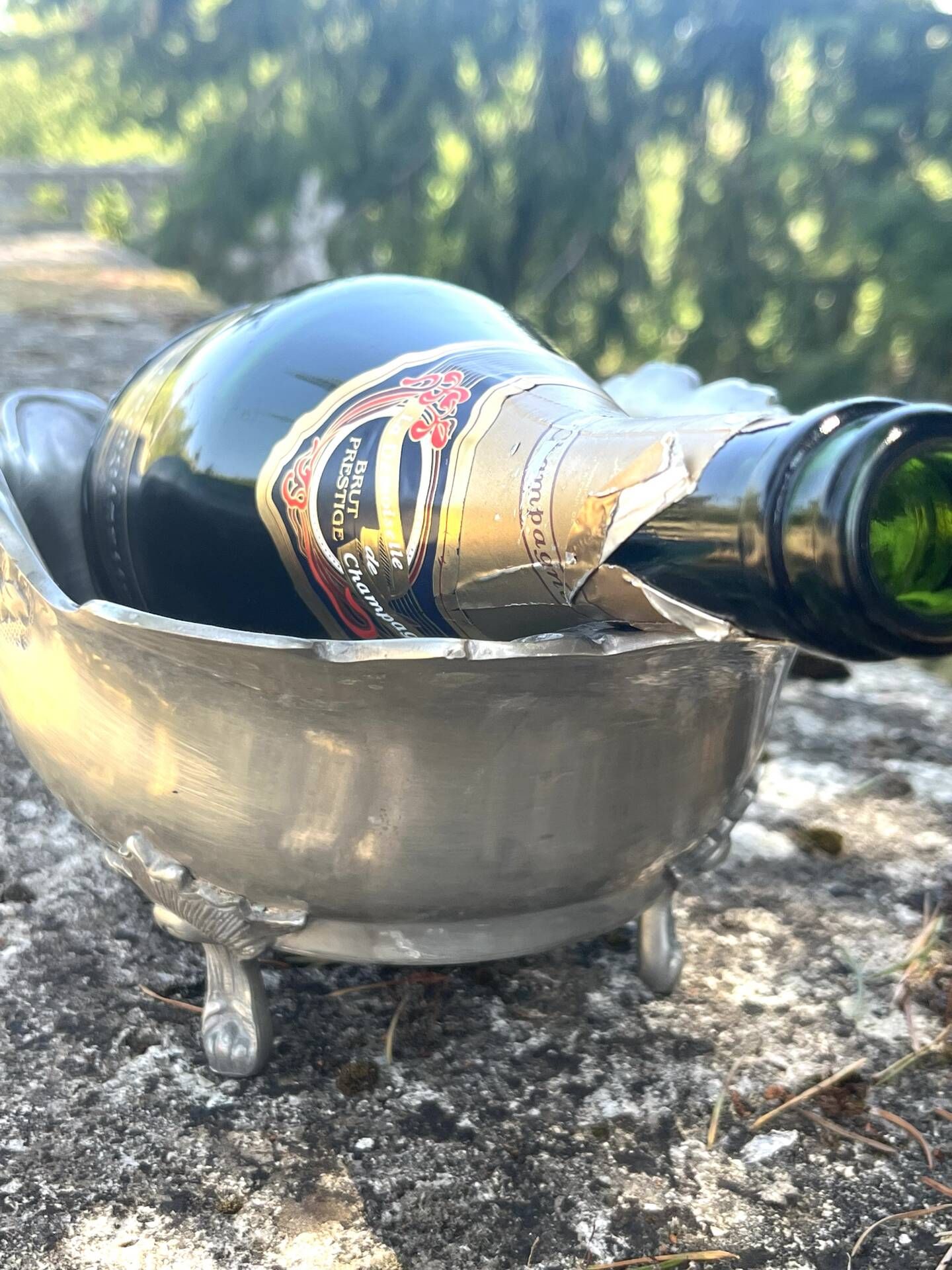 Footed pewter champagne cooler on claw feet with floral relief