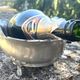 Footed pewter champagne cooler on claw feet with floral relief