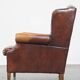 Comfortable, elegant, stately wing chair made of sheepskin in a beautiful warm color