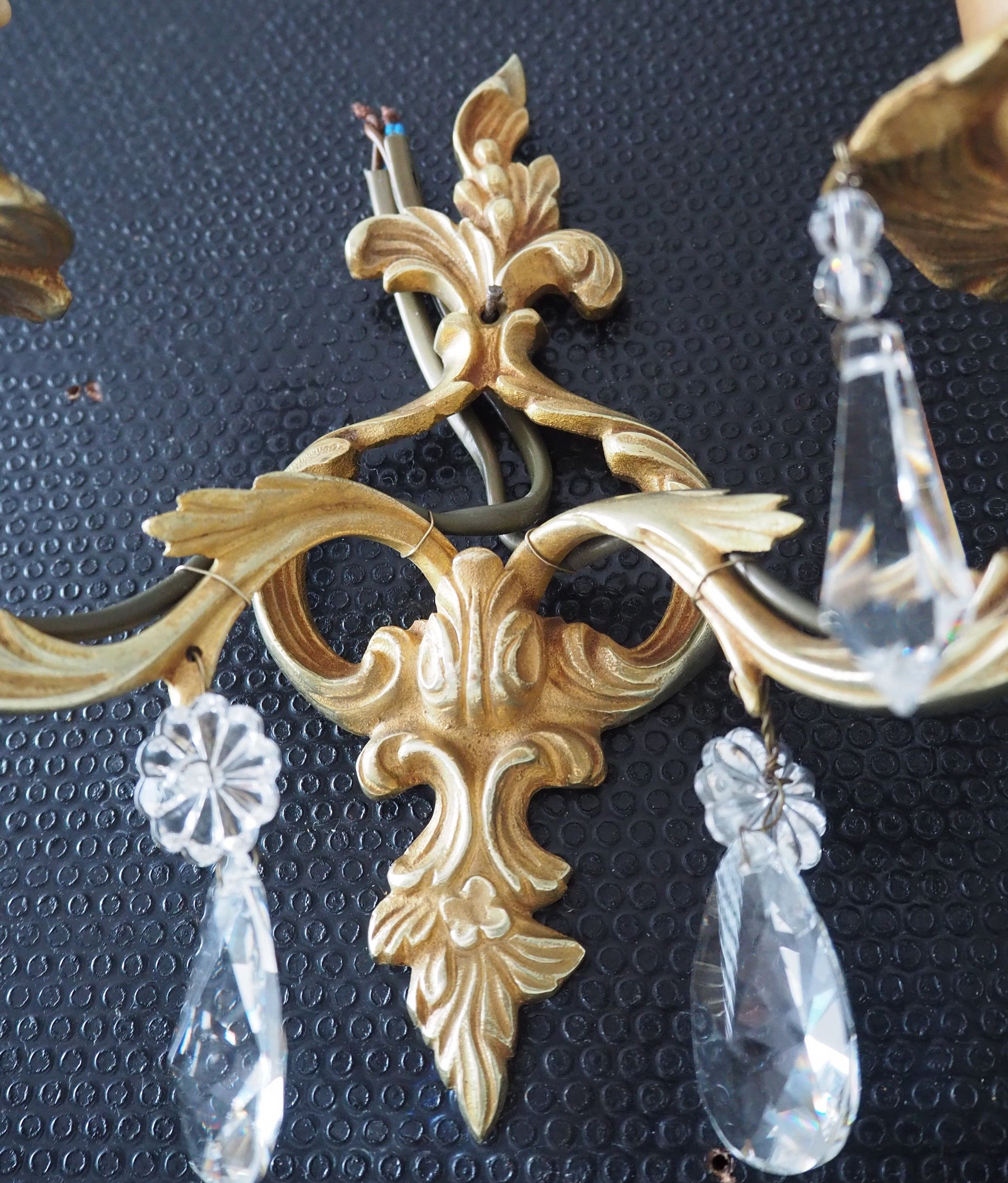 Pair of gilded bronze sconces and crystal pendants