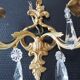 Pair of gilt bronze wall sconces with crystal pendants.