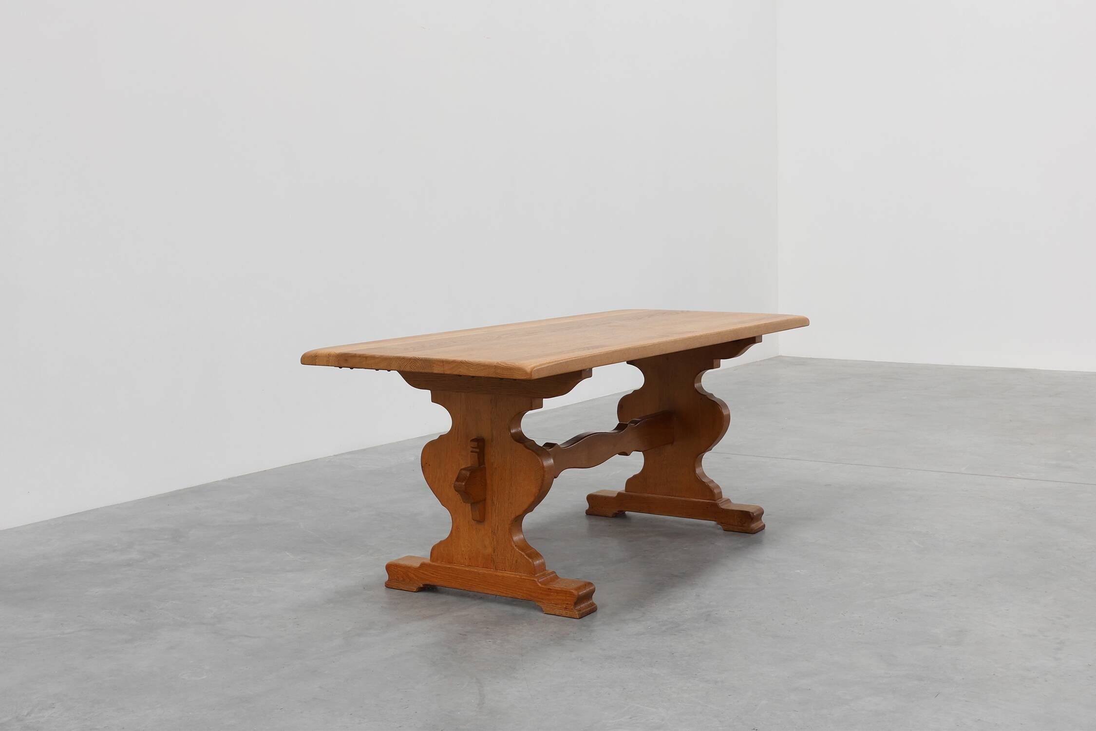 20th Century French oak trestle table with scalloped legs and plank top